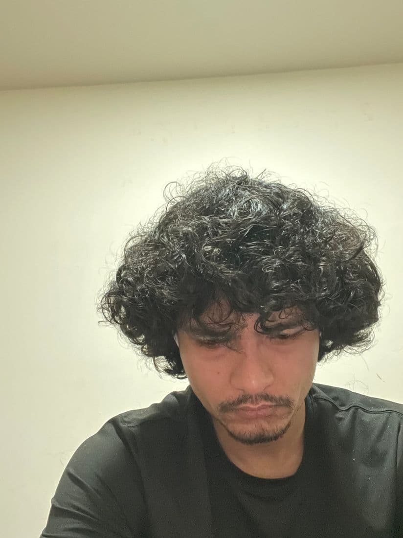 Close-up of the hairline with damp curls after application