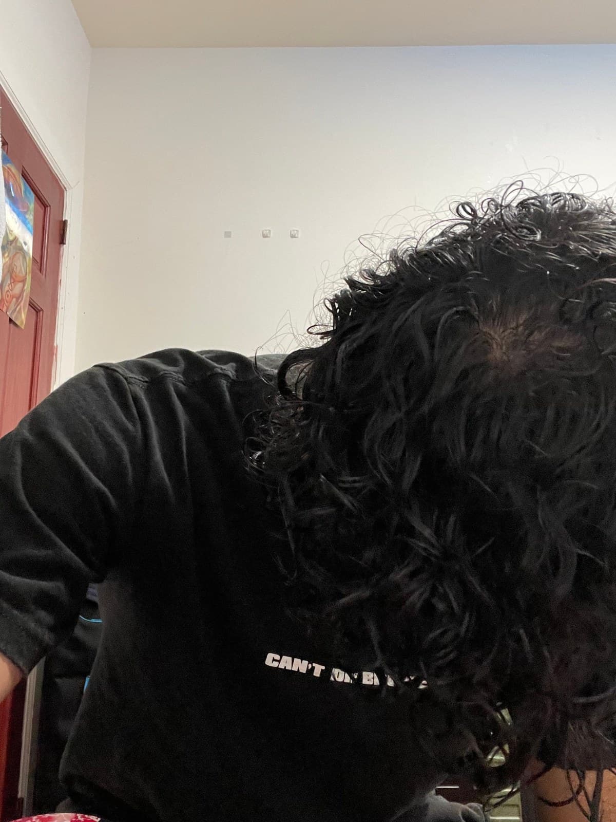 Wet curls hanging forward during the shampoo
